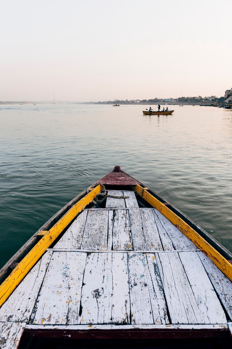 wooden-boat-sailing-river-ganges-varanasi-india_53876-146799